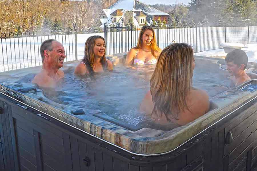 Family enjoying hot tub in winter