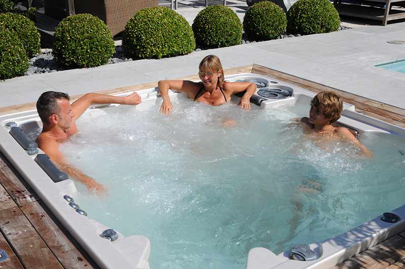 family relaxing in hot tub
